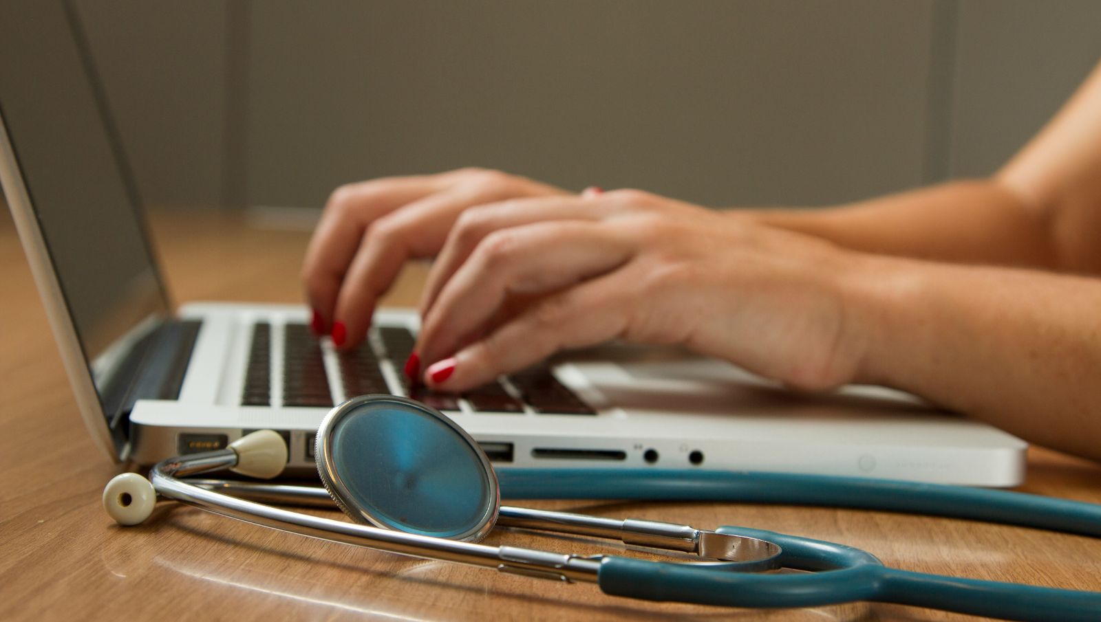 A certifying physician in Alabama using a laptop to submit a patient’s medical cannabis recommendation to the official AMCC registry portal.