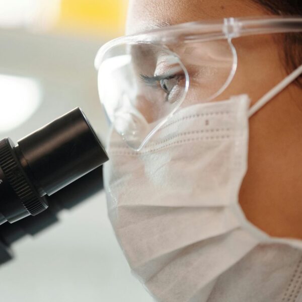 A laboratory scientist looking into a microscope to analyze medical cannabis terpene profiles for Alabama patients.