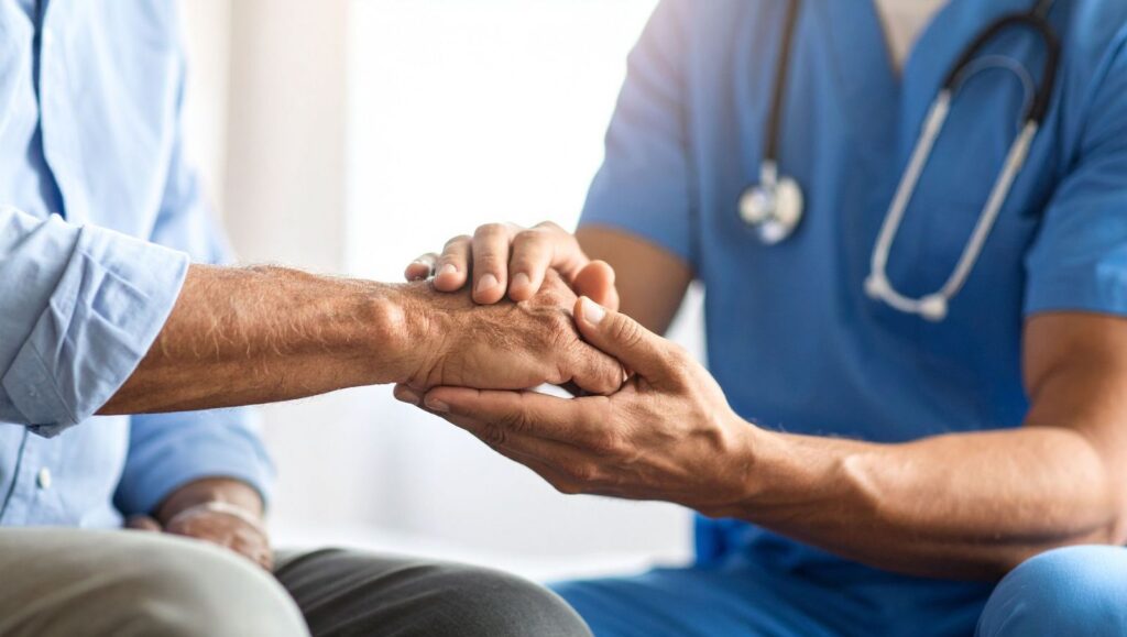 Physician holds an elderly male patient's hand during an in-person Alabama medical cannabis consultation