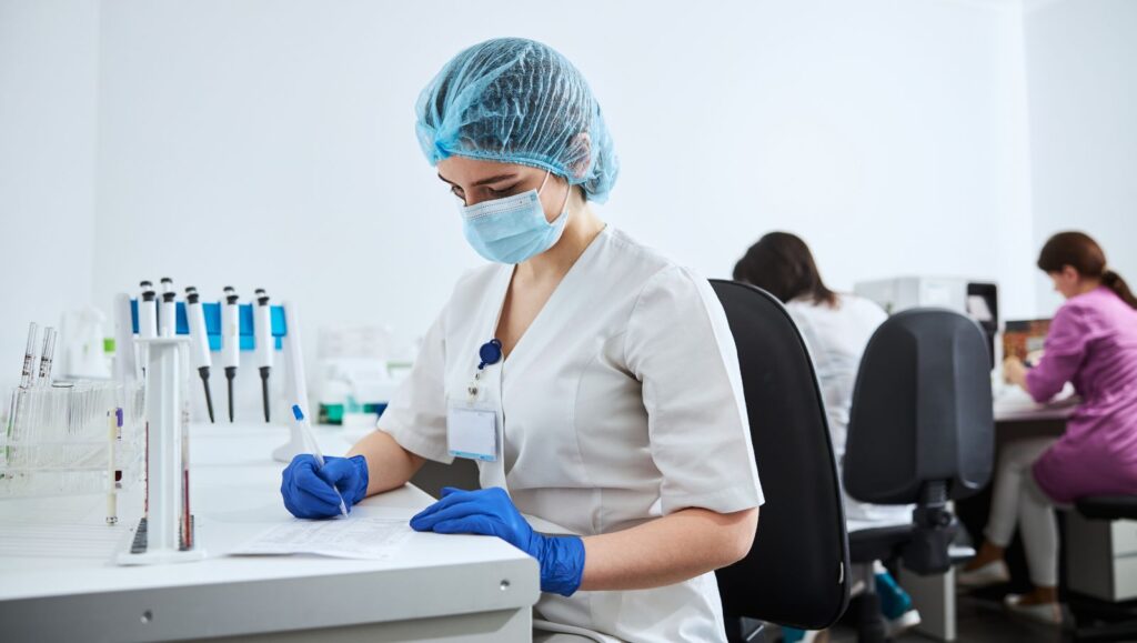 Laboratory analyst reviewing cannabis certificate of analysis results showing cannabinoid potency