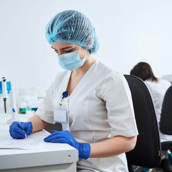 Laboratory analyst reviewing cannabis certificate of analysis results showing cannabinoid potency