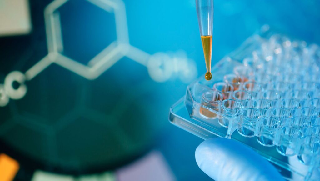 Close-up of a dropper adding a drop of liquid to a laboratory sample tray during cannabis lab testing