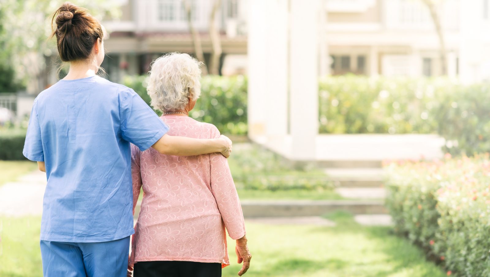 Registered medical cannabis caregiver in Alabama walking outdoors with a senior patient