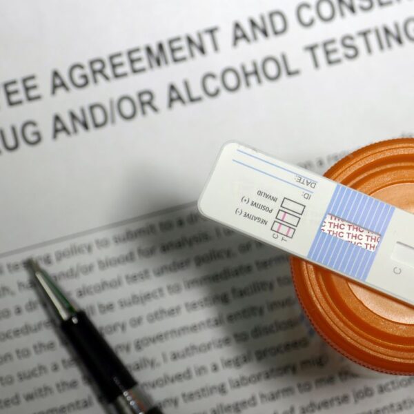A close-up view of an employee agreement form consenting to workplace drug testing.