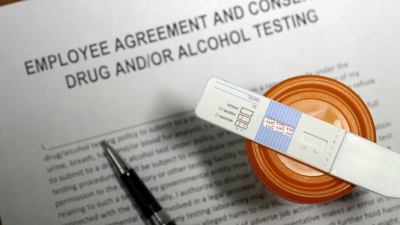 A close-up view of an employee agreement form consenting to workplace drug testing.