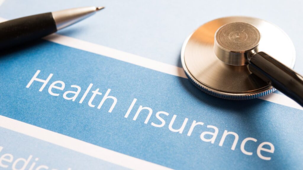 Close-up view of printed health insurance policy documents resting on a desk.