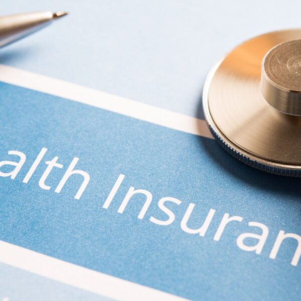 Close-up view of printed health insurance policy documents resting on a desk.