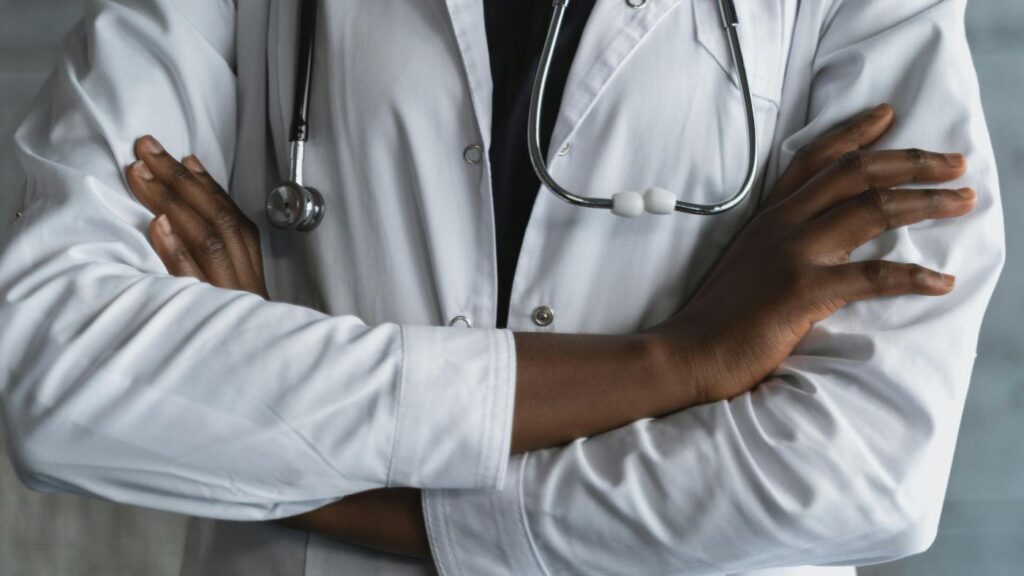 Close-up of a physician with arms crossed, offering a clinical perspective on medical cannabis vs. hemp and CBD in Alabama.