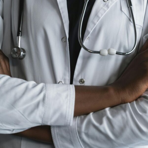Close-up of a physician with arms crossed, offering a clinical perspective on medical cannabis vs. hemp and CBD in Alabama.